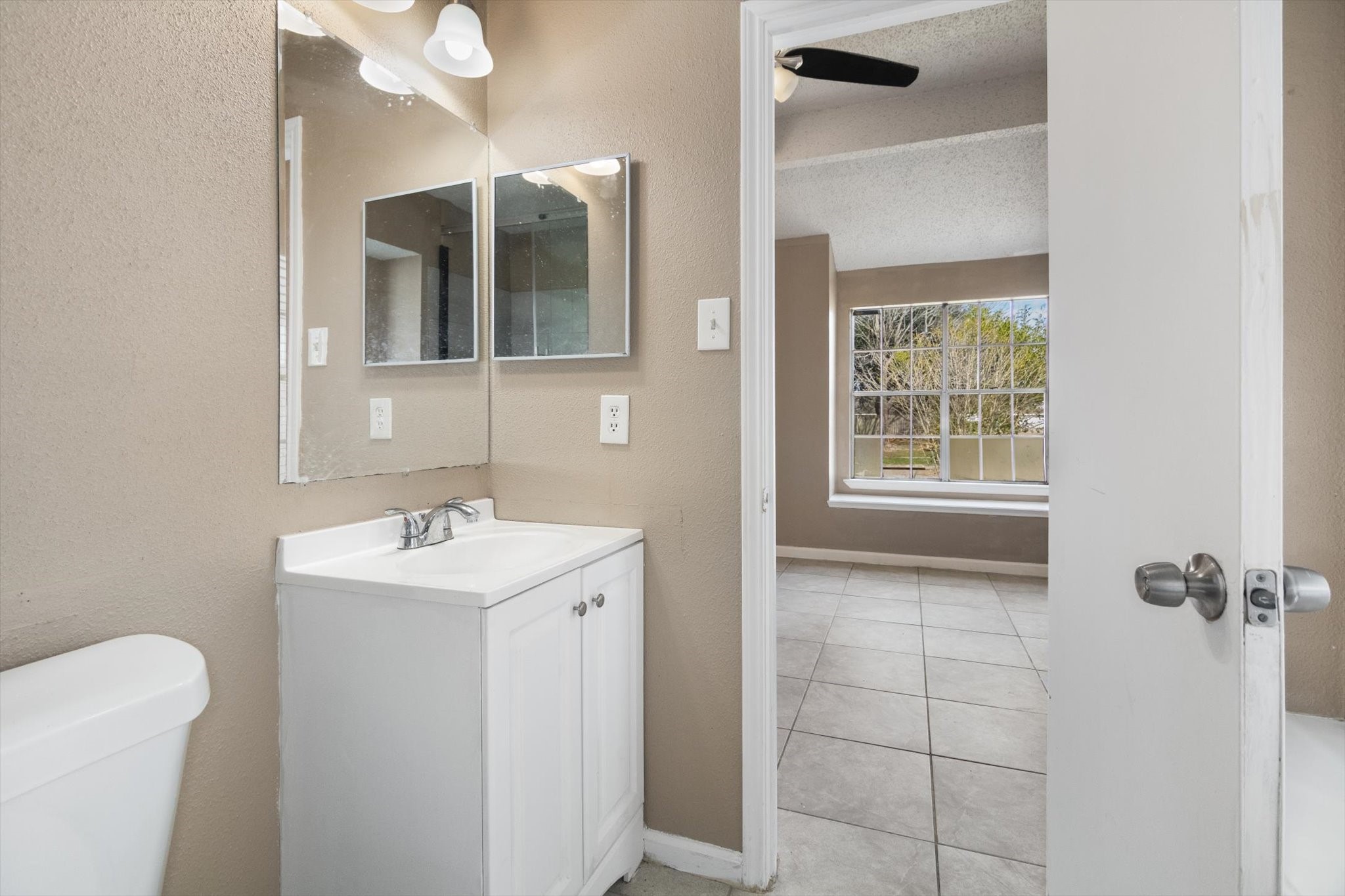 4403 Conward Drive Houston, TX 77066 - Photo 18 of 25 a bathroom with a toilet sink and mirror