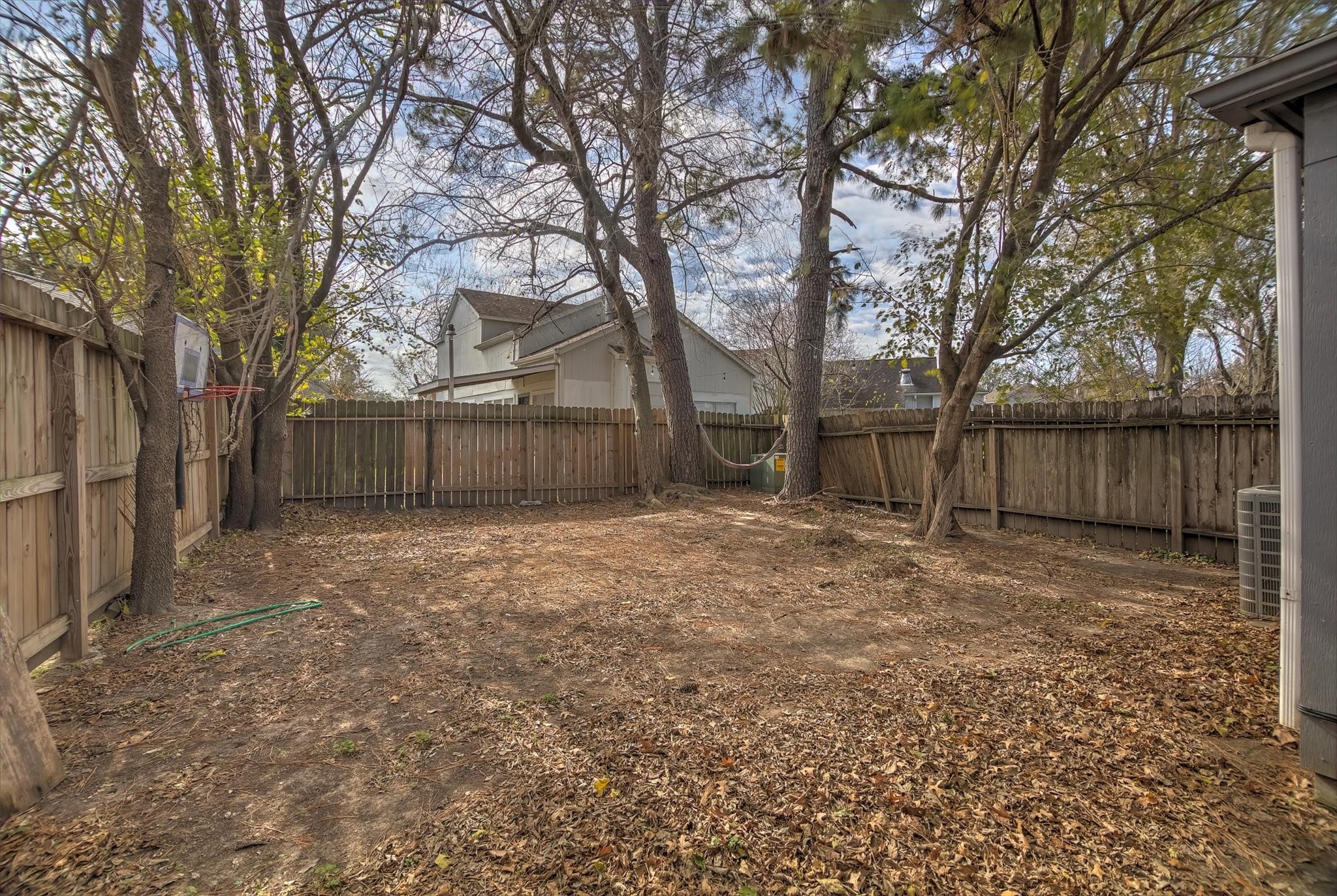 4403 Conward Drive Houston, TX 77066 - Photo 24 of 25 a view of a backyard with large trees and wooden fence