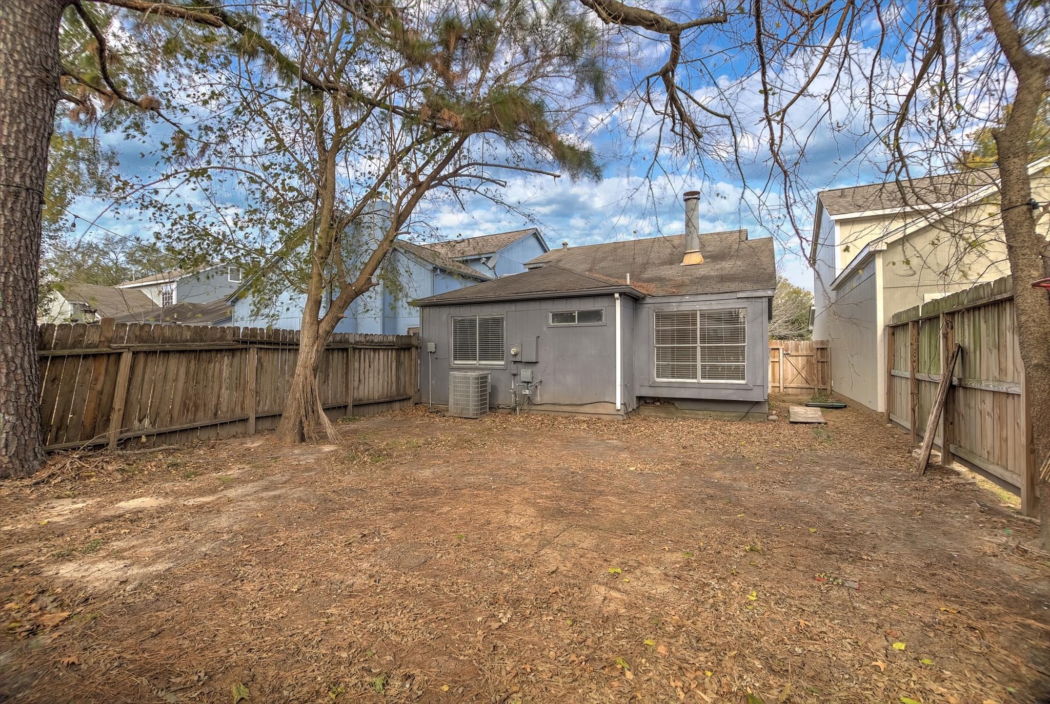 4403 Conward Drive Houston, TX 77066 - Photo 25 of 25 a view of a house with a large tree and wooden fence