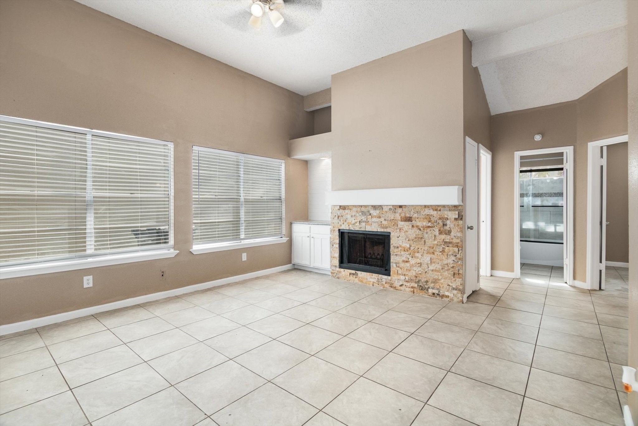 4403 Conward Drive Houston, TX 77066 - Photo 4 of 25 an empty room with windows and fireplace