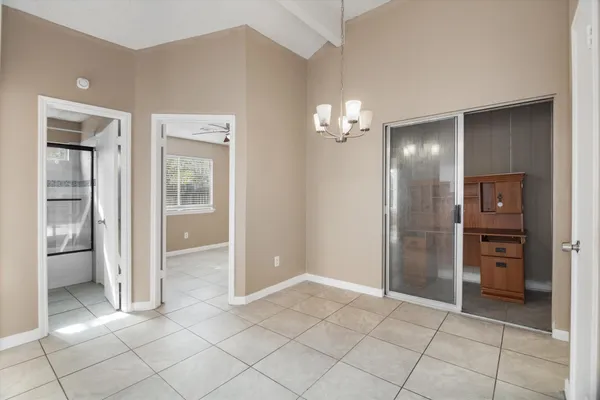 a view of an empty room with a fireplace and a window