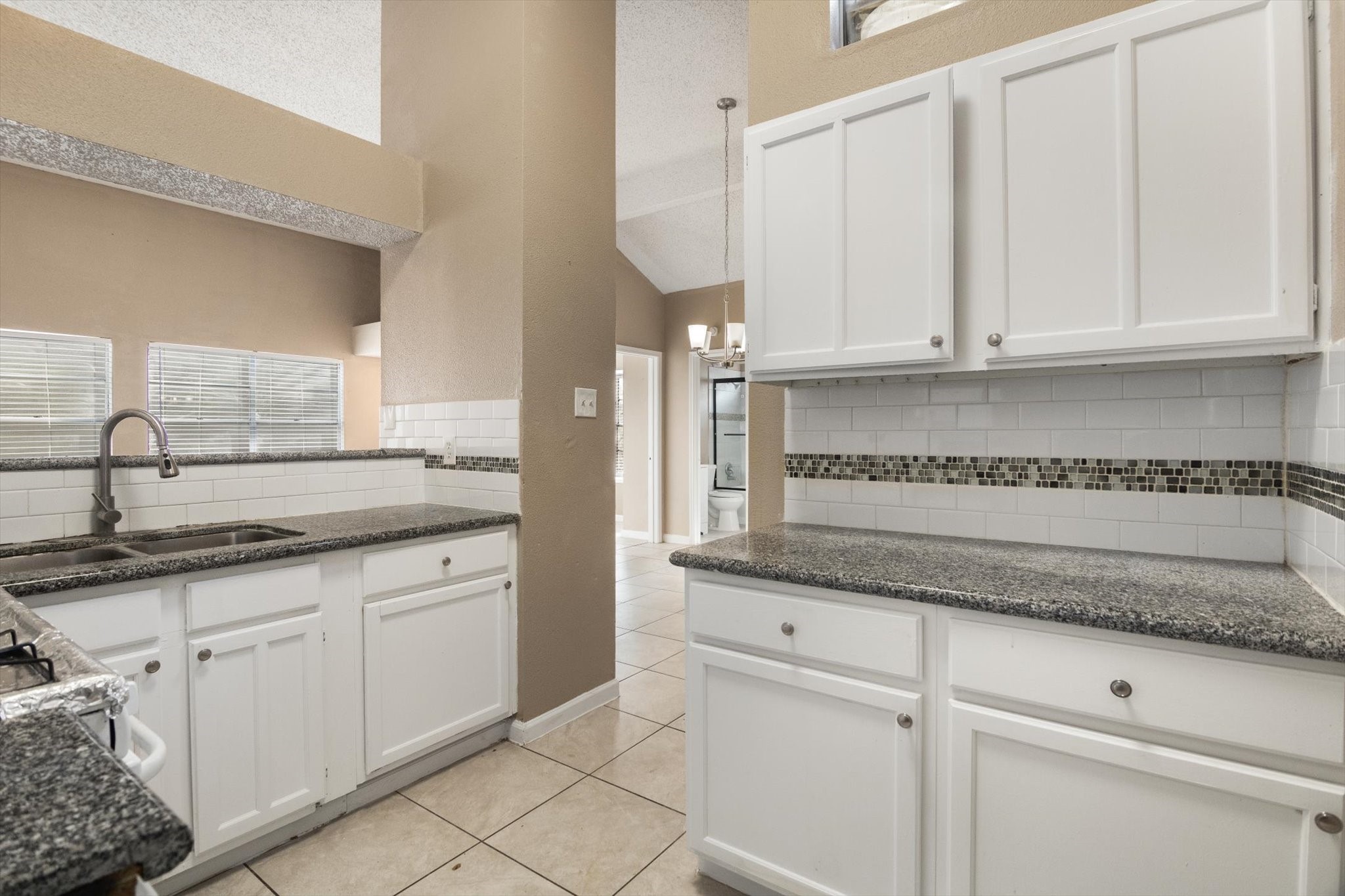 4403 Conward Drive Houston, TX 77066 - Photo 10 of 25 a kitchen with granite countertop white cabinets and a sink