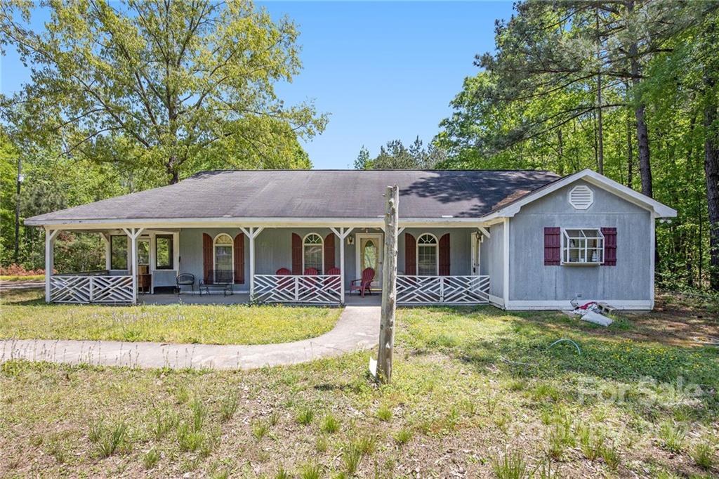 340 Sally Blackwell Road Pageland, SC 29728 - Photo 1 of 30 a view of a house with swimming pool and a yard