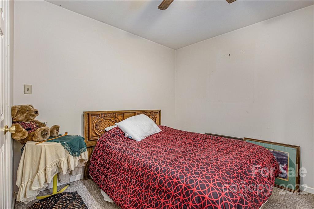 340 Sally Blackwell Road Pageland, SC 29728 - Photo 13 of 30 a bedroom with a bed and a painting on the wall