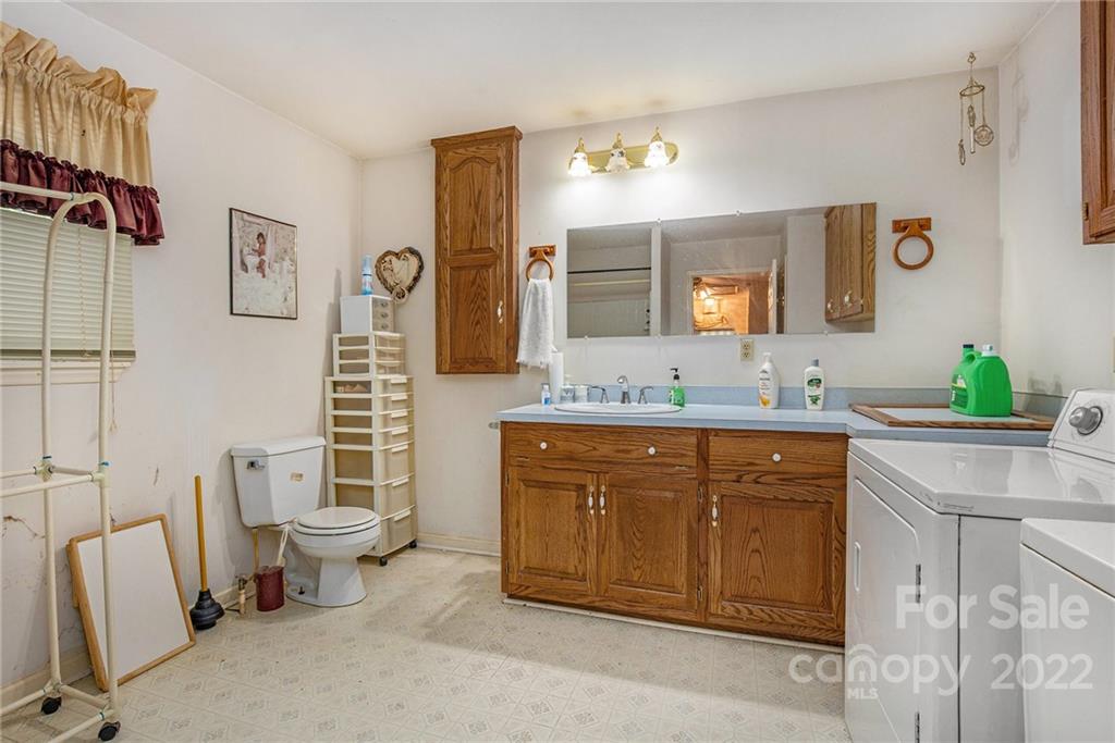 340 Sally Blackwell Road Pageland, SC 29728 - Photo 19 of 30 a spacious bathroom with a granite countertop sink mirror and a toilet