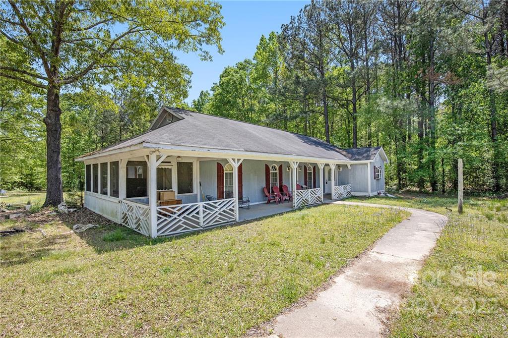 340 Sally Blackwell Road Pageland, SC 29728 - Photo 22 of 30 a front view of a house with garden