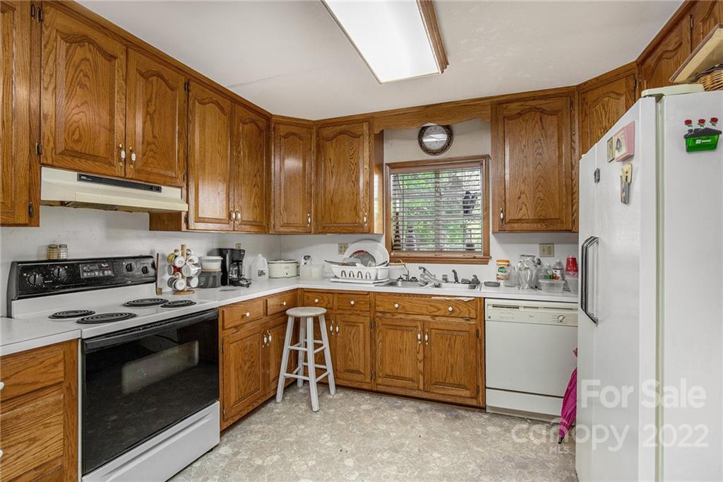 340 Sally Blackwell Road Pageland, SC 29728 - Photo 3 of 30 a kitchen with stainless steel appliances granite countertop a stove sink and cabinets