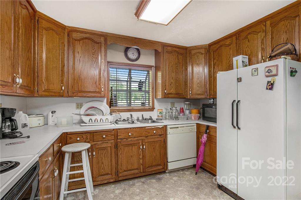 340 Sally Blackwell Road Pageland, SC 29728 - Photo 4 of 30 a kitchen with a refrigerator a stove a sink and cabinets