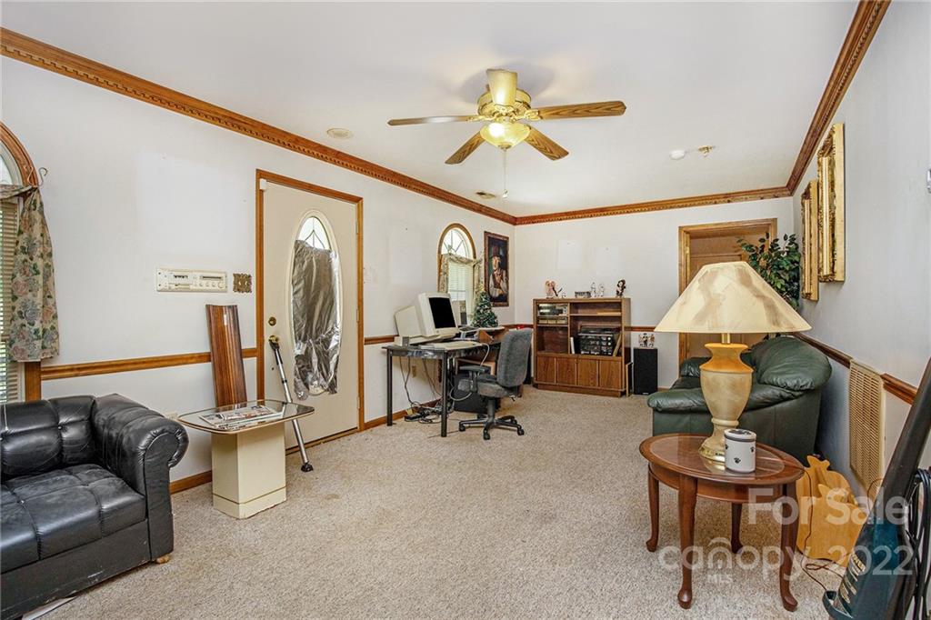 340 Sally Blackwell Road Pageland, SC 29728 - Photo 10 of 30 a living room with furniture and a chandelier