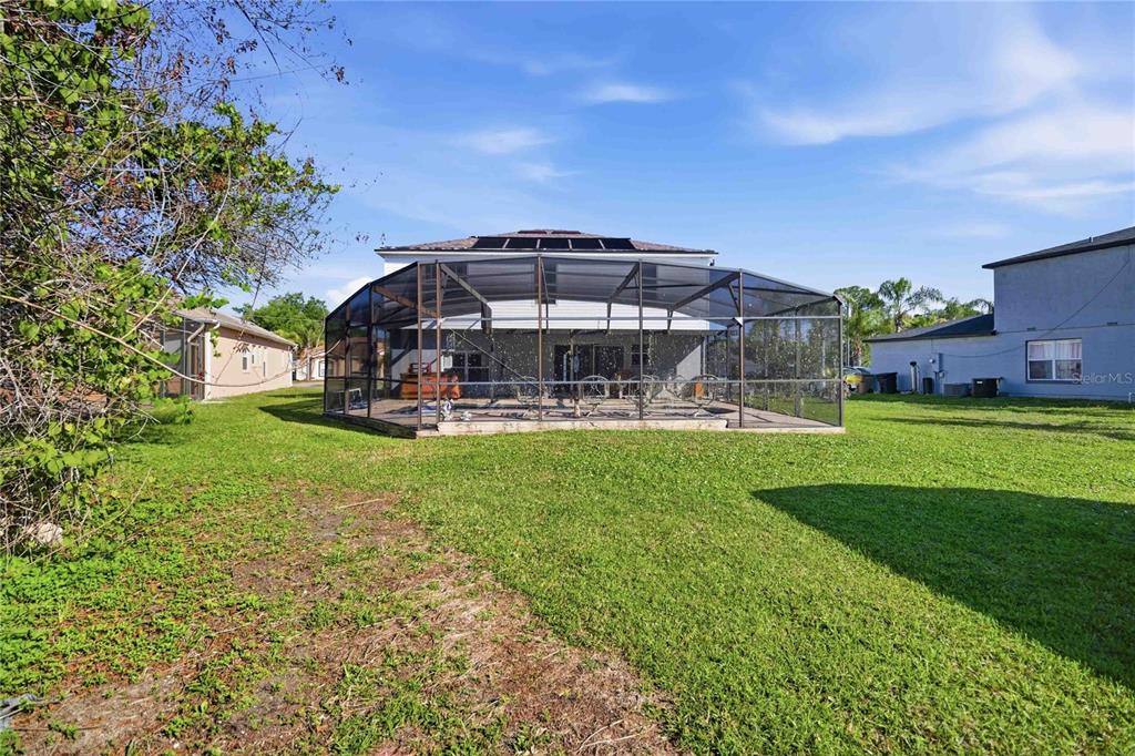 206 Taranto Way Kissimmee, FL 34758 - Photo 40 of 45 a view of a big yard with table and chairs under an umbrella