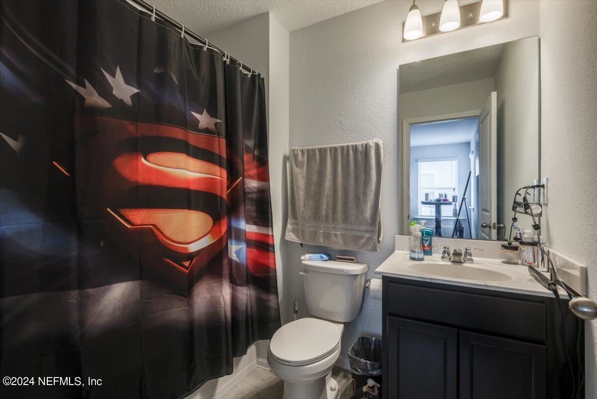 668 Watervale Drive St. Augustine, FL 32092 - Photo 12 of 17 a bathroom with a toilet sink and mirror