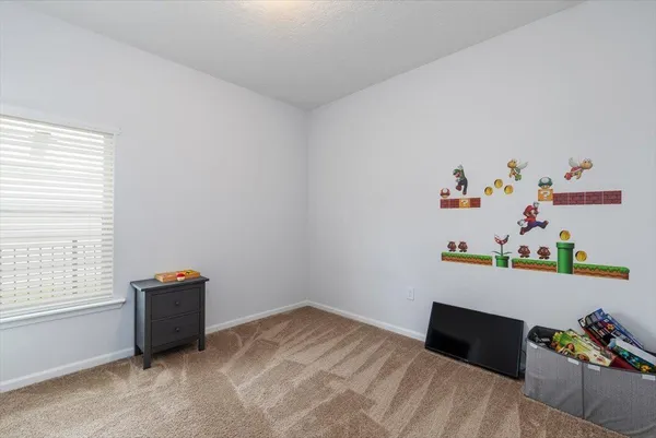 a bedroom with a bed and a desk