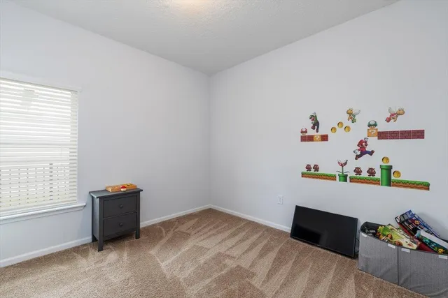 a bedroom with a bed and a desk