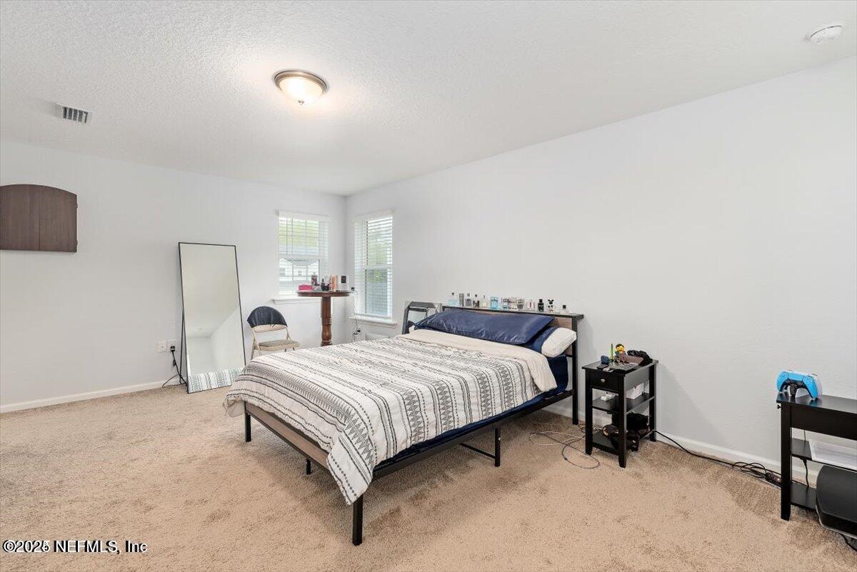 668 Watervale Drive St. Augustine, FL 32092 - Photo 14 of 17 a bedroom with a bed and a desk