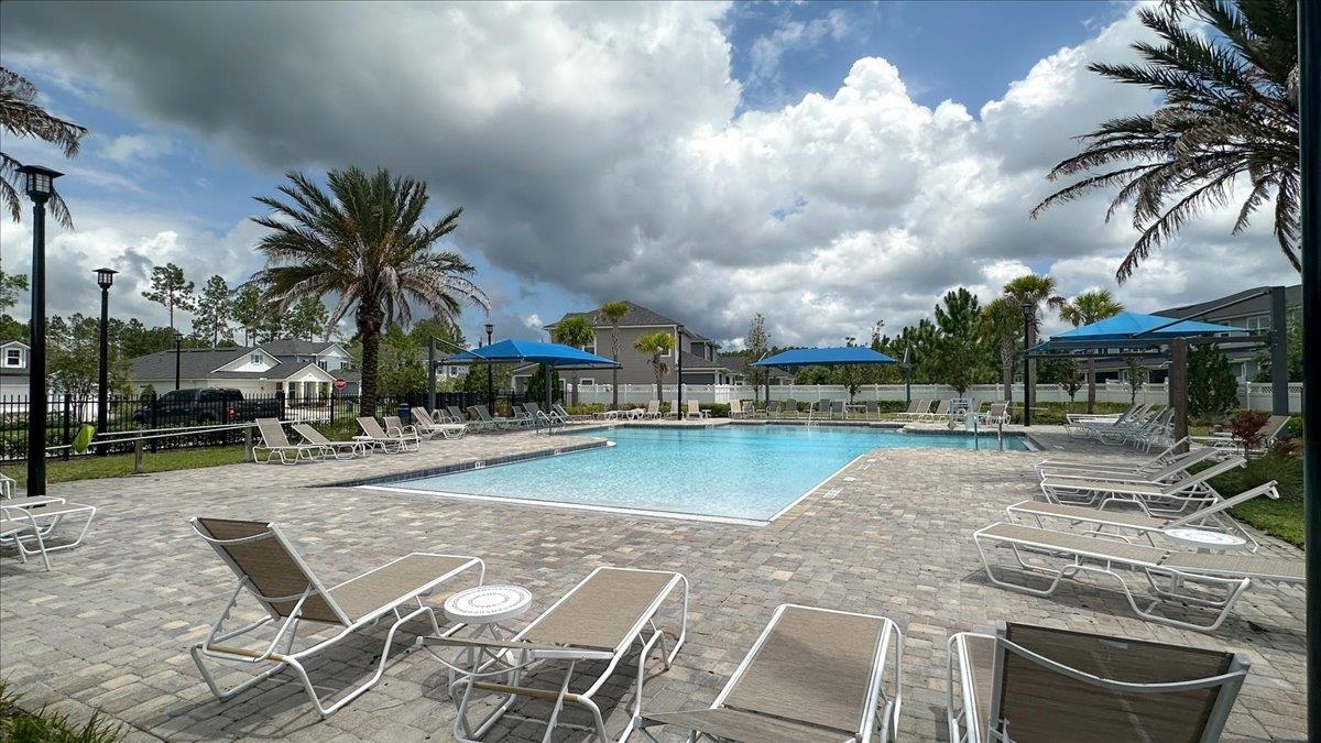 668 Watervale Drive St. Augustine, FL 32092 - Photo 16 of 17 a view of a swimming pool with a table and chairs