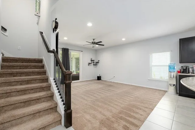 a view of a livingroom with furniture and staircase