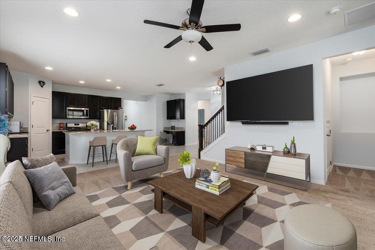 668 Watervale Drive St. Augustine, FL 32092 - Photo 6 of 17 a living room with furniture and a flat screen tv