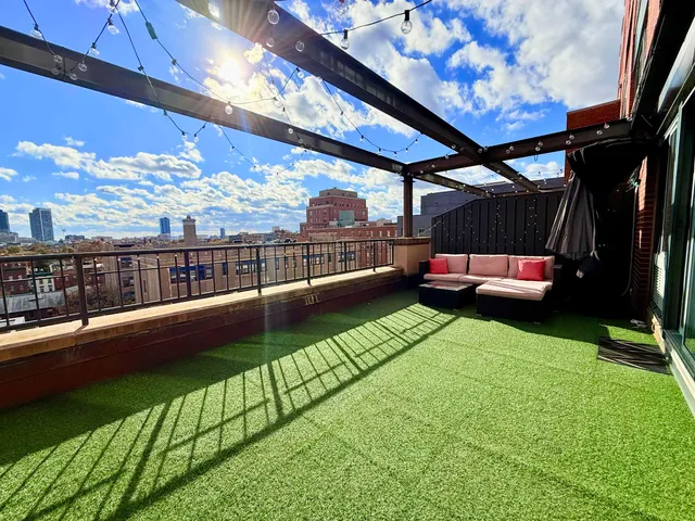 a view of a house with a yard and a sitting area