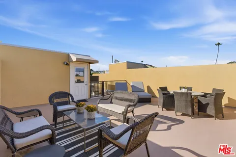 a balcony with table and chairs