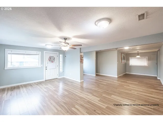 a view of an empty room and wooden floor