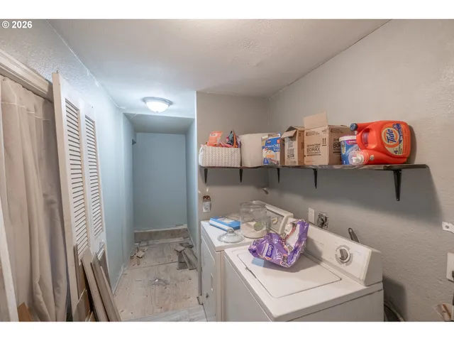 a view of a room that has a table and a book shelf