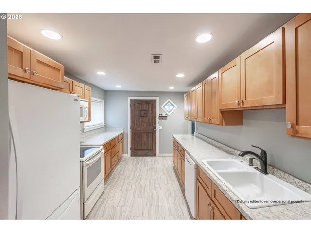 a kitchen with stainless steel appliances granite countertop a sink stove and refrigerator