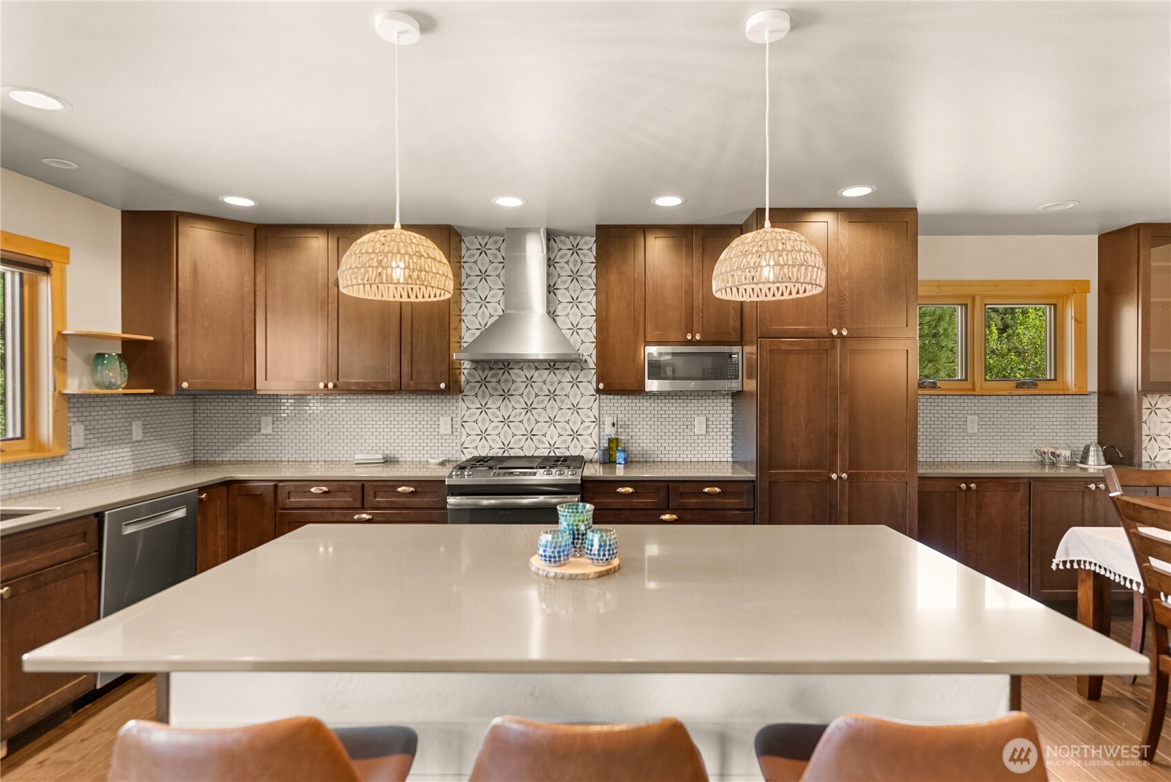 130 Sundown Road Winthrop, WA 98862 - Photo 14 of 40 a kitchen with a sink a stove and chairs