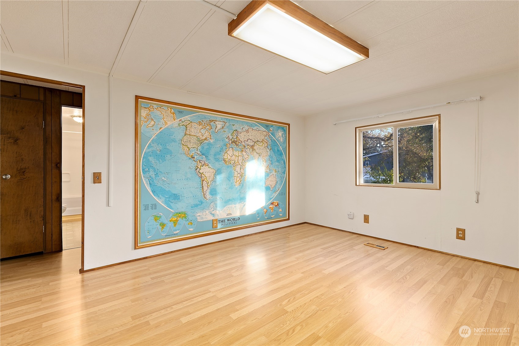18124 Wakly Lane Southwest Rochester, WA 98579 - Photo 20 of 30 a view of an empty room with wooden floor and a window