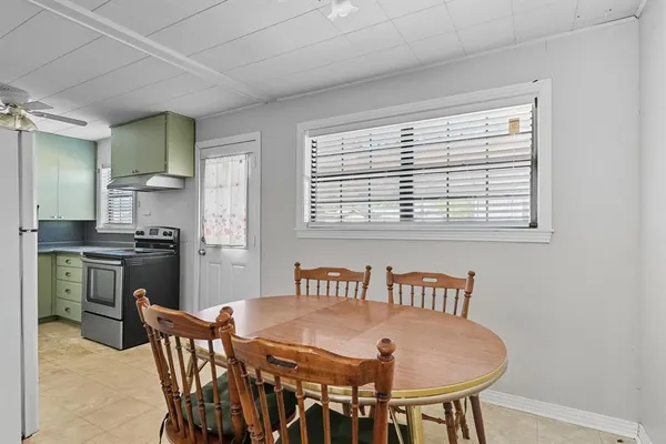 a view of a dining room with furniture and a window