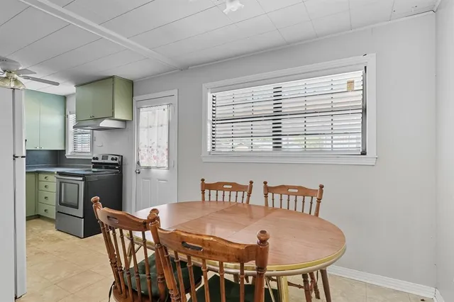 a view of a dining room with furniture and a window