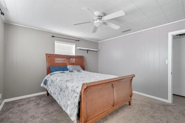 a bedroom with a bed and a ceiling fan