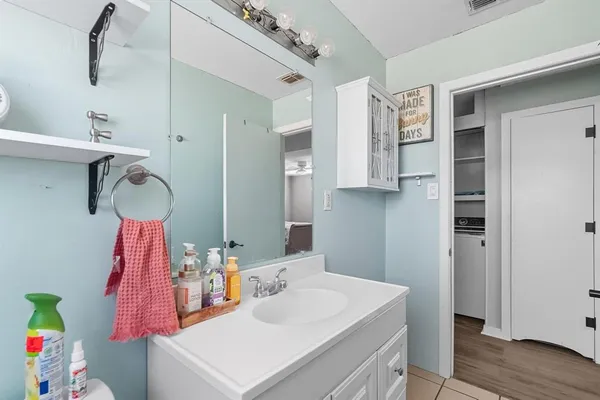 a bathroom with a sink vanity and tub