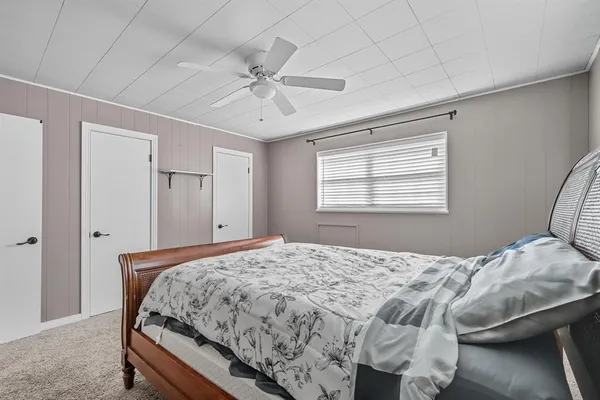 a bedroom with a large bed and a window