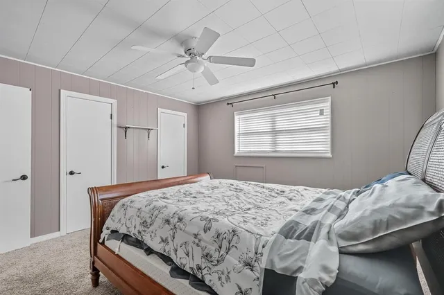 a bedroom with a large bed and a window