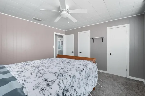 a bedroom with a large bed and a chandelier