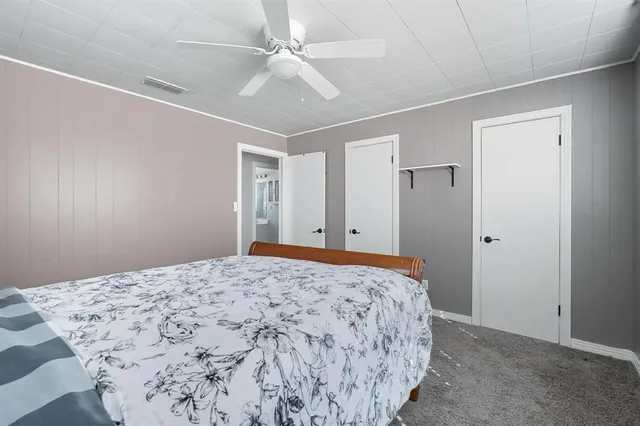 a bedroom with a large bed and a chandelier