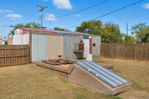 a wooden bench sitting in front of a building