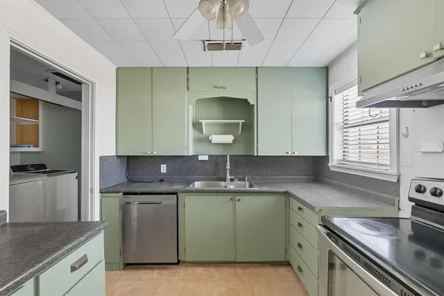 a kitchen with a sink cabinets and window