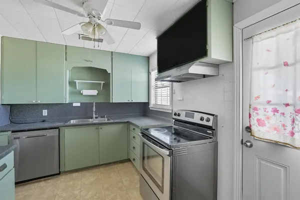 a kitchen with a sink stove and cabinets