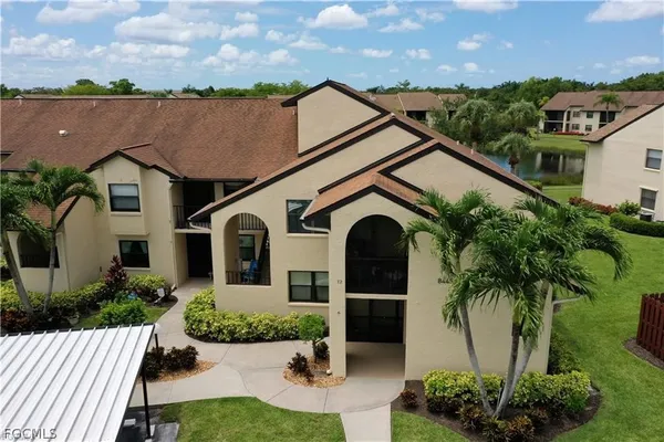 an aerial view of a house with a yard and potted plants