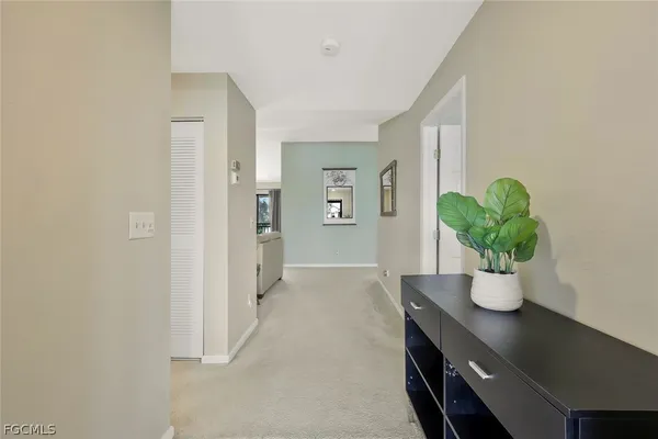 a living room with furniture and potted plant