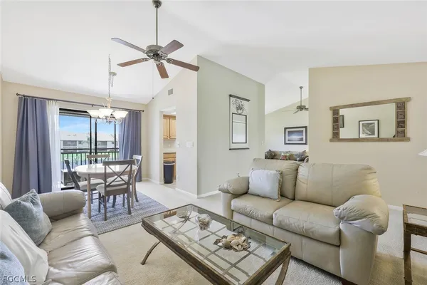 a living room with furniture ceiling fan and a rug