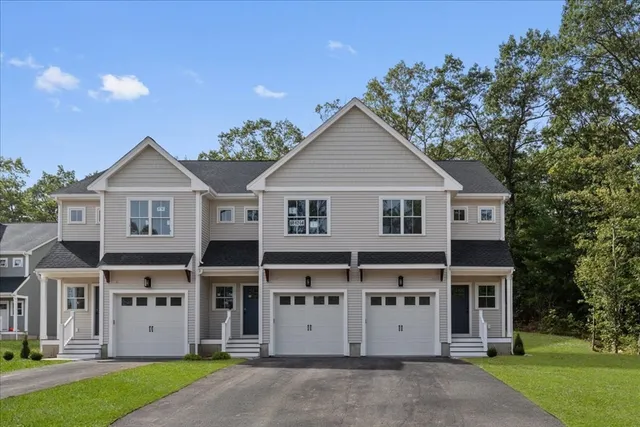 a view of a big house with a big yard and large trees
