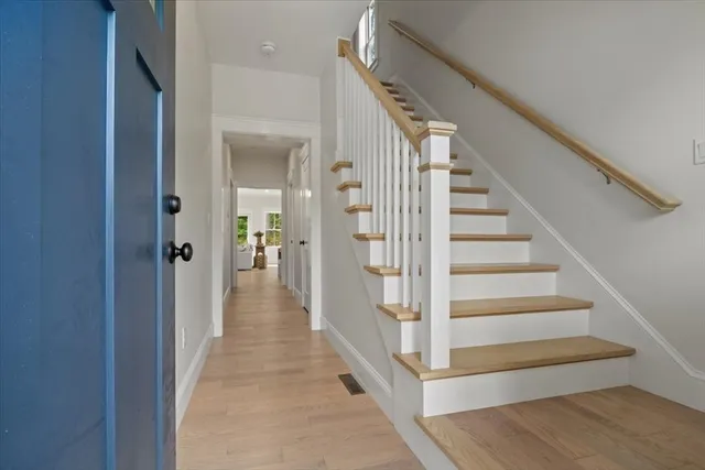 a view of a hallway with wooden floor and entryway
