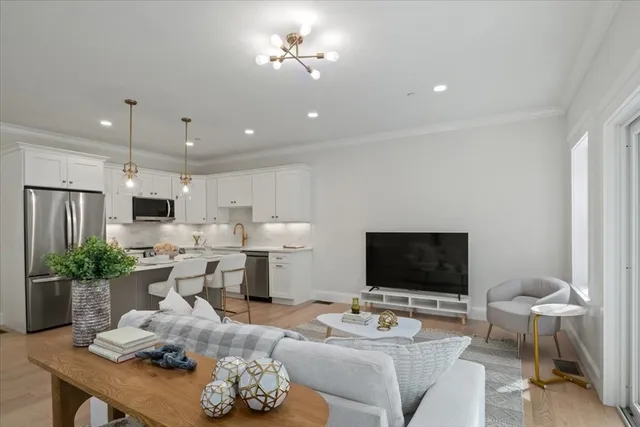 a living room with furniture a flat screen tv and a fireplace