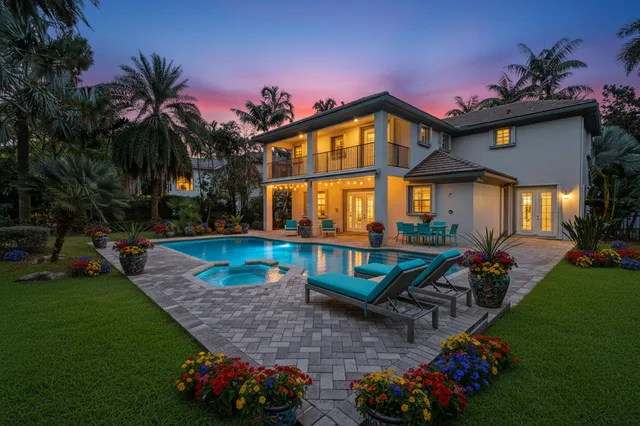 a front view of house with a garden