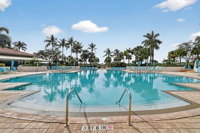 a front view of a house with a yard and potted plants