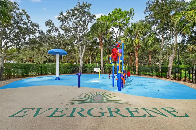 a view of a house with a yard and potted plants