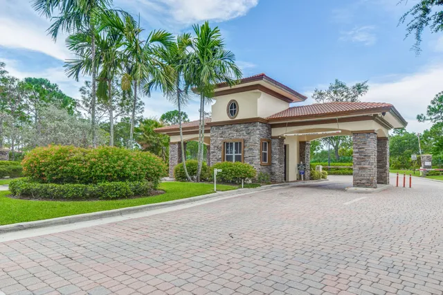 a view of a patio with table and chairs under an umbrella