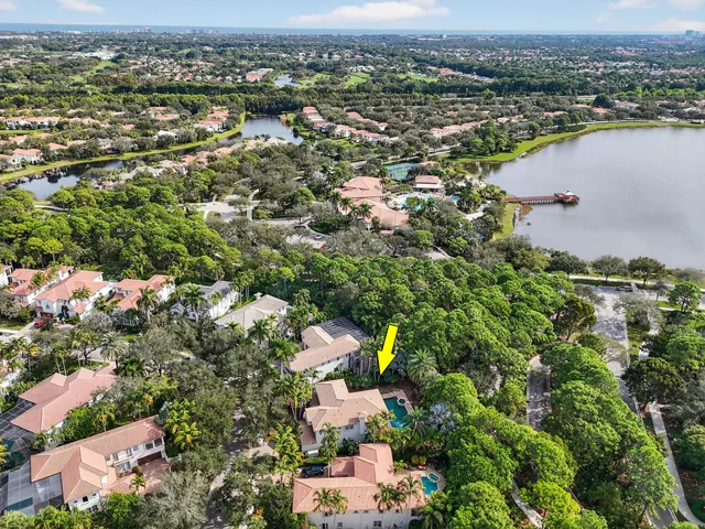 an aerial view of residential houses with outdoor space and trees